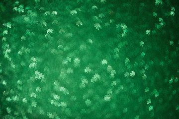 Clover shaped bokeh. St.Patrick 's Day. Blurred abstract background. Green shamrock