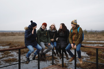 five people in the woods. Two girls and three guys in nature