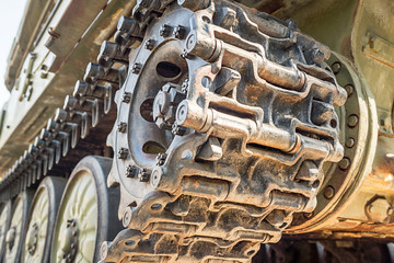 Tank caterpillar track with wheels. Caterpillar armored vehicle. Close-up