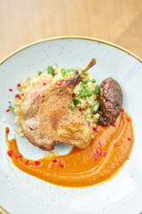 Plate Duck leg su-vide, with bulgur and onion marmalade. Barbecue restaurant menu, a series of photos of different meats