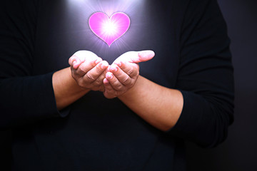 hand with shining heart shape holy spiritual bokeh light effect, Love for all concept