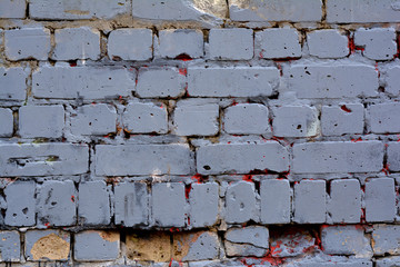 Old gray brick wall with traces of red paint for background or texture - Powered by Adobe