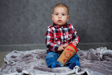 Fototapeta premium little boy ten months old in a shirt and jeans