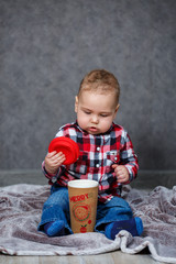 Naklejka premium little boy ten months old in a shirt and jeans