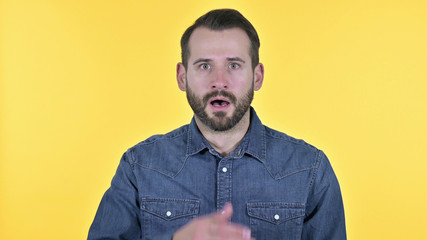 Portrait of Disappointed Young Man Feeling Shocked, Yellow Background