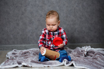 Fototapeta premium little boy ten months old in a shirt and jeans