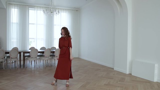 the girl with red hair was dressed in a beautiful dress, in a room with chairs