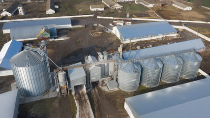 Large silver tanks of the elevator at the agro-industrial complex.