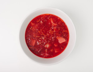 Fresh beetroot soup isolated on white background