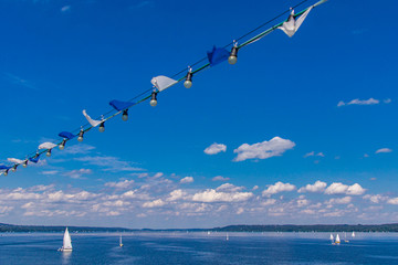 Fototapeta na wymiar Weiß-blaue Wimpel über dem sommerlichen See