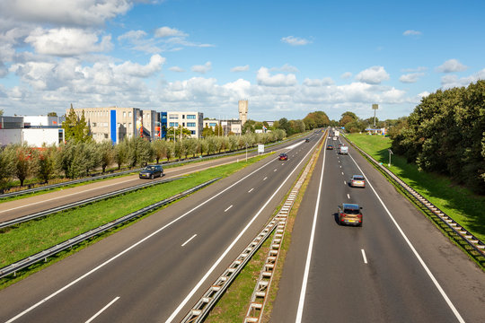 Cars driving on the A44 highway in the village of Sassenheim in the Netherlands.