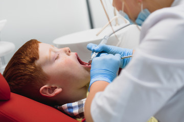 Boy satisfied with the service in the dental office. concept of pediatric dental treatment