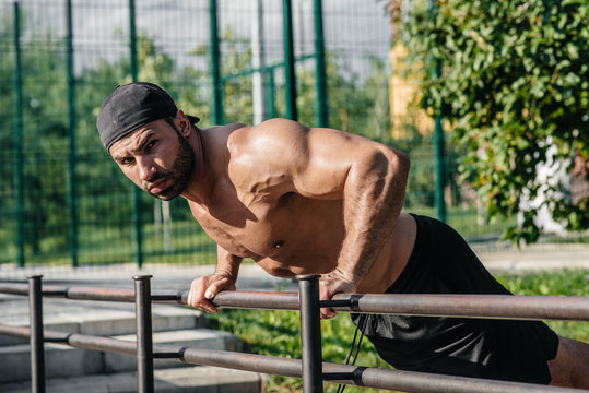 A fitness athlete trains on a sports field. Healthy lifestyle