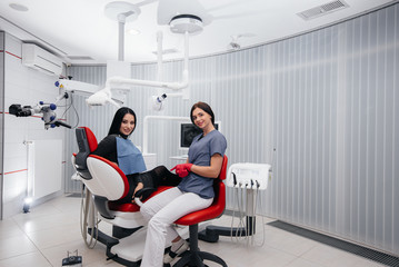 Fototapeta premium The dentist shows a picture of the patient's teeth and tells the necessary treatment. Dentistry, health.