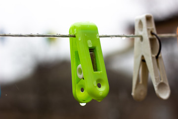 Blue sky setting and laundry tongs. Tongs for clothes hang. Tongs for clothes hang on a wire