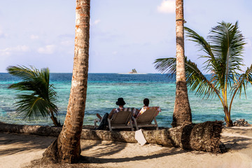 People relaxing on beautiful beach on Caribbean San Blas island at politically autonomous Guna territory in Panama.