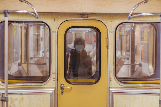 Woman in medical mask traveling in subway train