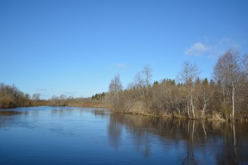 view to river with reflections and blue cloudy sky