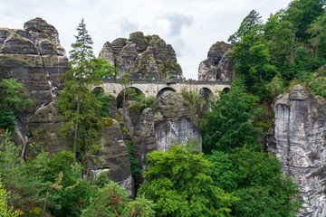 Fototapeta na wymiar Famous bridge Basteibruecke in Saxon Switzerland on a cloudy day