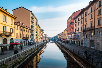 Naklejka na ściany i meble Milan, Navigli (Darsena) people walking on the banks of the canal on a sunny winter day