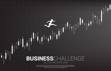 Naklejka premium Silhouette of businessman jumping on growing candle graph. Concept of people ready to start career and business