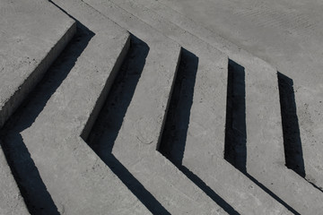 concrete curvilinear steps without a ramp. The falling shadow from a product from concrete in the...