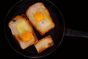 Fried toasts with egg inside in a pan. Traditional french dish. Rustic breakfast