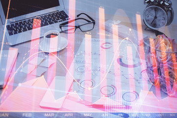 Forex market chart hologram and personal computer background. Double exposure. Concept of investment.