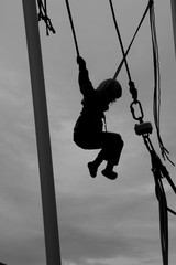 Low Angle View Of Girl Swinging Against Sky