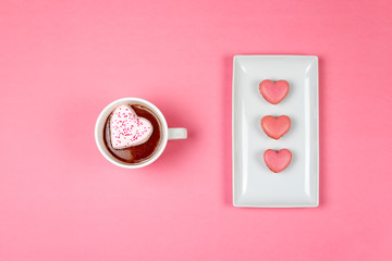 Top view of hot cocoa and heart shaped macaroons