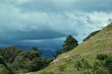 Fototapeta premium Cloudy sky outside the Pumapungo Museum with some Inca ruins