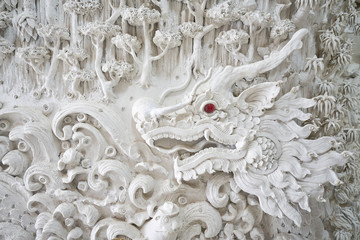 dragon sculpture on wall in huai pla kung temple chiang rai