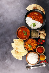 Chicken tikka masala spicy curry meat food in pot with rice and naan bread. indian food on table