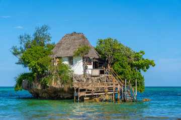 Home on the rock on high tide in sea water on the island of Zanzibar, Tanzania, Africa - obrazy, fototapety, plakaty
