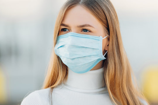 Young woman outdoors wearing a mask against coronavirus