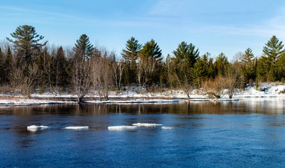 Fototapeta na wymiar Wisconsin River in Merrill, Wisconsin starting to melt