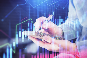 Double exposure hands with stock market chart.