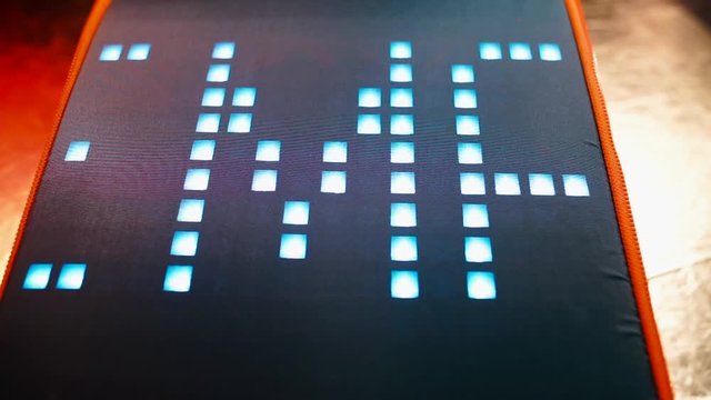 The word feminine is written on a digital display in pixel letters. Gender designation concept.
