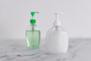hygiene against viruses and bacteria, hand sanitizer and liquid soap bottle on marble bathroom