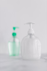 hygiene against viruses and bacteria, hand sanitizer and liquid soap bottle on marble bathroom