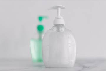 hygiene against viruses and bacteria, hand sanitizer and liquid soap bottle on marble bathroom
