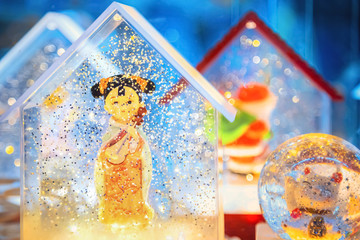 A Chinese doll in a snowglobe 