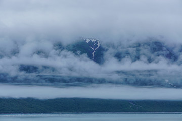 Yakutat Bay, Alaska, USA: Clouds descending on a mountainside at the edge of Yakutat Bay.