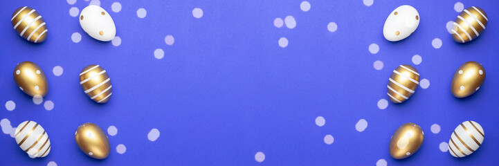 Easter egg background with golden shine decorated eggs in basket isolated on blue. Happy Easter