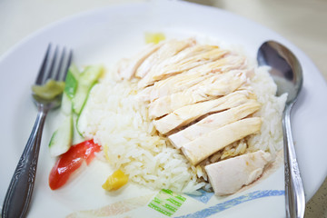 Traditional Asian Chinese Street Food: Khao Man Kai (Kao Man Gai) is Hainanese chicken rice, steamed chicken meat and white rice. Khao Man is cooked rice in an oily or coconut sauce, Kai is chicken.