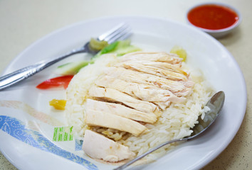 Traditional Asian Chinese Street Food: Khao Man Kai (Kao Man Gai) is Hainanese chicken rice, steamed chicken meat and white rice. Khao Man is cooked rice in an oily or coconut sauce, Kai is chicken.