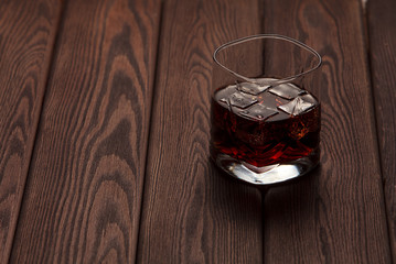 whiskey with ice on a wooden table