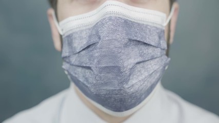Young man with Medical Mask On Face moving toward camera. Virus Infection Protection Measures. coronavirus prevention icon - Powered by Adobe
