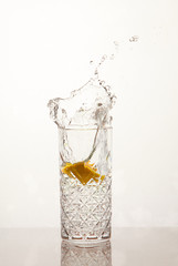 Fresh glass of water with lemon, water splash