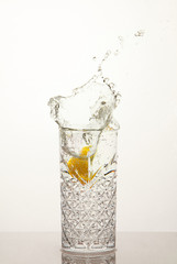 Fresh glass of water with lemon, water splash